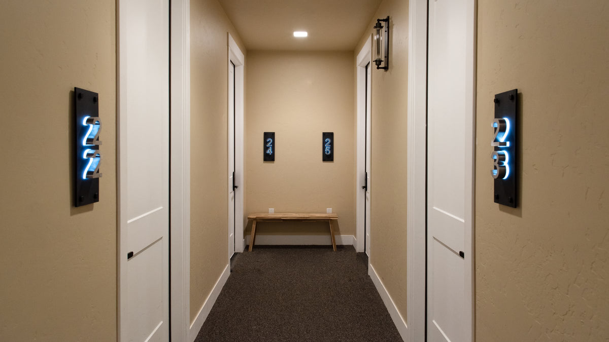 Lit suite numbers on doors along an interior corridor